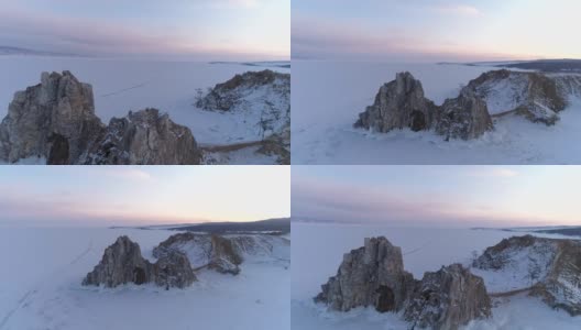 空中轨道拍摄的日落Olkhon岛上的沙曼卡岩石。冬天的风景。受欢迎的旅游目的地。自然地标。全景高清在线视频素材下载