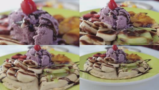 在华夫饼上放上冰淇淋、水果和巧克力糖浆高清在线视频素材下载