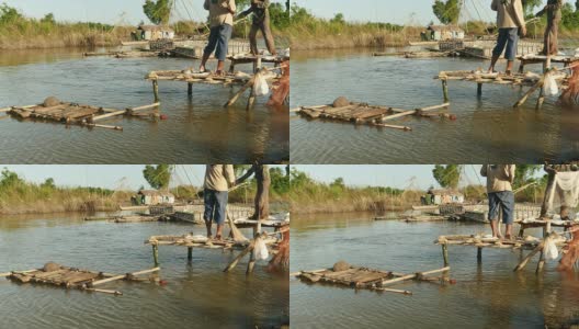 一个渔民从一个小的木制平台上向池塘里撒网。高清在线视频素材下载