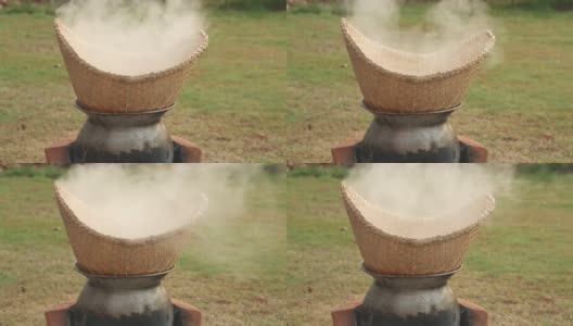 把米饭粘在竹编和锅里蒸熟。高清在线视频素材下载