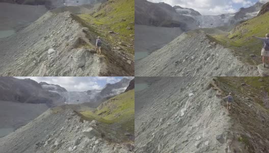 一名年轻女子在瑞士的山脊上徒步旅行的无人机镜头高清在线视频素材下载