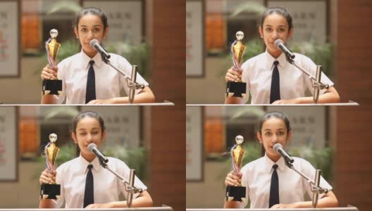女学生在颁奖典礼上举起奖杯并致辞高清在线视频素材下载