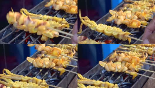 在食品市场的烤架上烤鱿鱼是泰国的街头小吃高清在线视频素材下载