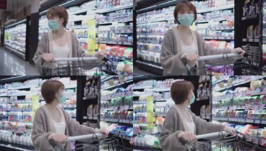 年轻女子在超市购物带着口罩保护高清在线视频素材下载