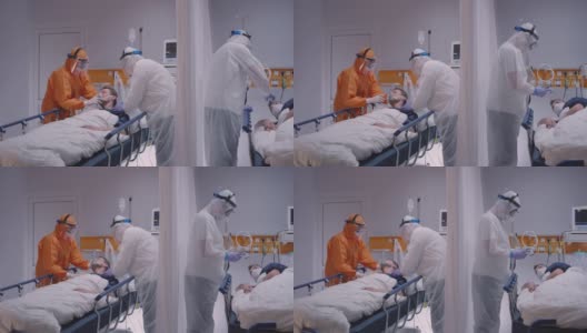 身穿防护服的医生给冠状病毒患者戴上氧气面罩-宽幅慢镜头摄影高清在线视频素材下载