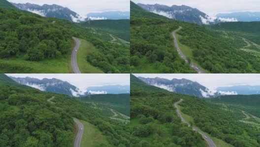 无人机跟踪的汽车行驶在蜿蜒的山路高清在线视频素材下载