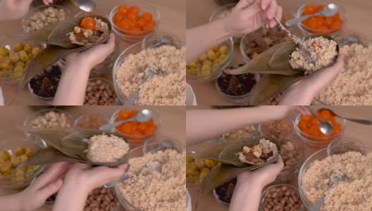 制作粽子——家庭准备食物配料的粽子一起制作在家里的木桌上庆祝端午节，近距离，生活方式。高清在线视频素材下载