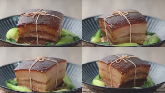 东坡肉(东坡肉)在一个漂亮的蓝色盘子与绿色清江蔬菜，传统的节日食品为中国新年美食餐，闭合，旋转，锅。高清在线视频素材下载