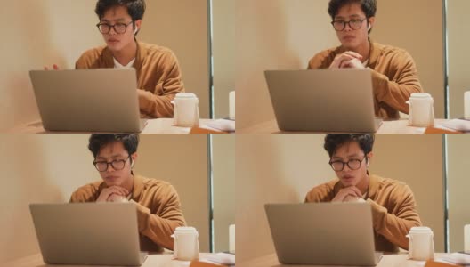 亚洲年轻员工男子通过数码平板电脑视频通话的慢镜头，与合作伙伴商议项目计划，对商业技术和新常态生活理念有新的想法高清在线视频素材下载