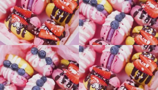 糖果盒，手工制作的精美食品，马卡龙，新鲜草莓和蓝莓装饰巧克力，精致的黄色和粉红色蛋糕，糖和健康食品高清在线视频素材下载