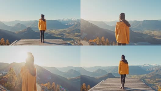 MS年轻女子走到平台的边缘，俯瞰阳光明媚，风景优美的山景，失败者山，奥地利高清在线视频素材下载
