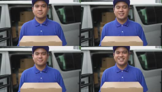 电晕病毒概念，Smiley蓝色英俊的亚洲男子拿着包裹纸箱站在货车前面。4k分辨率和慢动作拍摄。高清在线视频素材下载