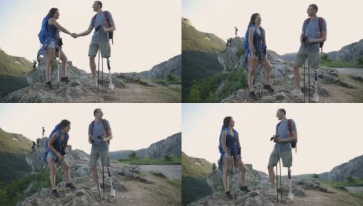 一对登山夫妇站在山顶上高清在线视频素材下载