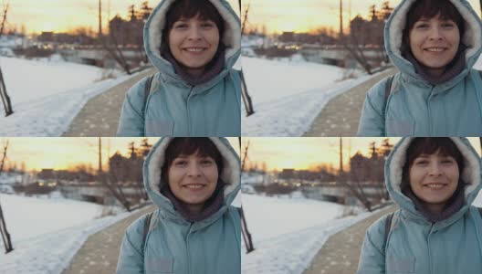 一个年轻女子的肖像在一个城市的背景在冬天。高清在线视频素材下载