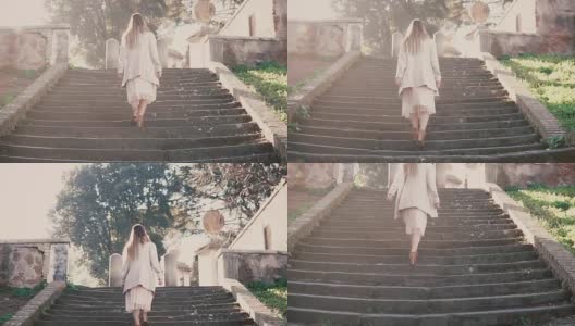 年轻时尚的女子走在城市老街上，爬着楼梯。在欧洲度假的女孩高清在线视频素材下载