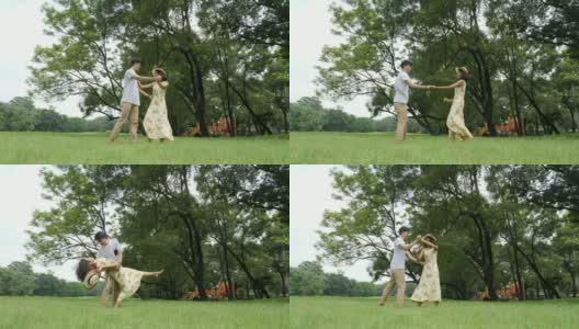 浪漫的亚洲情侣在花园中翩翩起舞。人以生活方式，放松情绪为理念。高清在线视频素材下载