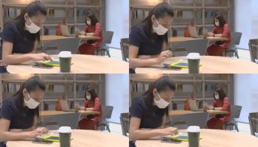 戴着防护面具的女人在办公室工作高清在线视频素材下载
