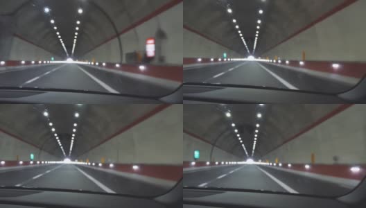 汽车穿过隧道驶向光明的尽头。无重点的观点拍摄高清在线视频素材下载