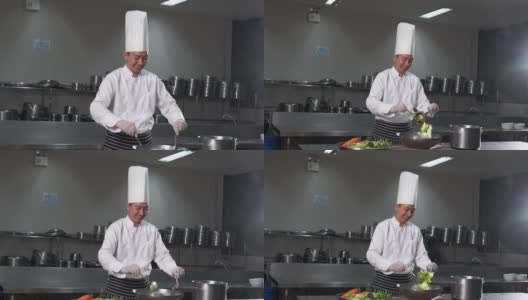 厨师在酒店餐厅的厨房里准备食物。高清在线视频素材下载