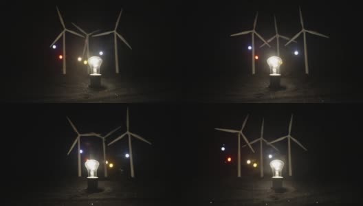 电力在自然界或清洁能源概念。风力发电机在晚上生产替代能源。由替代能源供电的发光灯泡。创意小微缩装饰。有选择性的重点高清在线视频素材下载