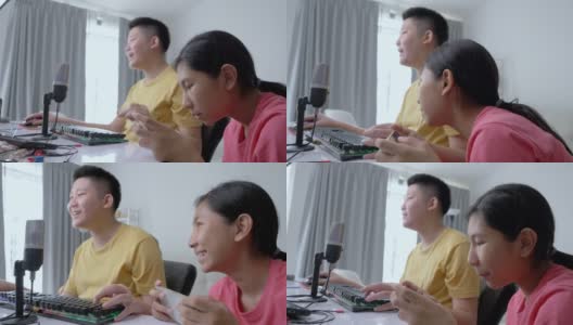 快乐的亚洲孩子们在家里一起玩在线游戏，这是新一代生活方式的时尚活动高清在线视频素材下载