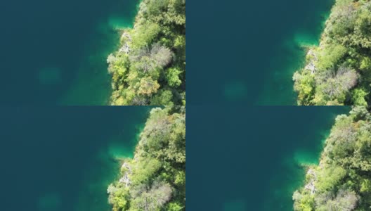 在一个阳光明媚的日子里，用无人机在纽约的弗普朗克一个废弃的采石场上空拍摄，充满了美丽的绿色水域。高清在线视频素材下载
