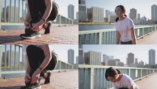 女子系鞋带开始在东京湾地区跑步高清在线视频素材下载