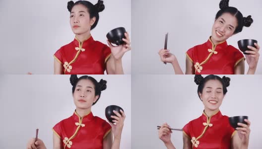 快乐的女人穿着中国旗袍，带着筷子和碗高清在线视频素材下载