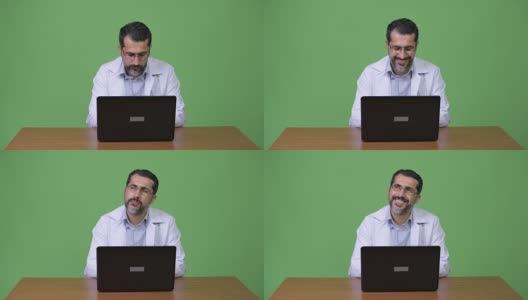 英俊的波斯胡子男子医生思考时使用笔记本电脑高清在线视频素材下载