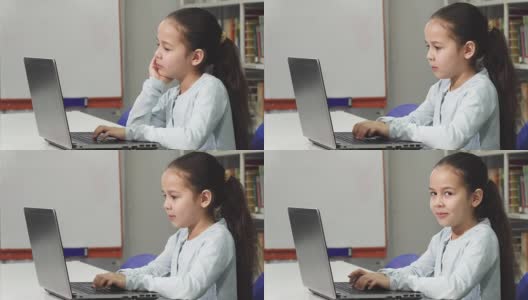快乐美丽的亚洲小女孩微笑，同时使用笔记本电脑高清在线视频素材下载