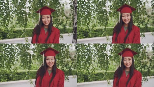 这是一幅迷人的亚洲女孩成功毕业的照片，她穿着学士服站在校园里，微笑着看着镜头。青年教育理念。高清在线视频素材下载