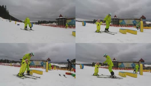 一个教练教一个小女孩如何滑雪。高清在线视频素材下载