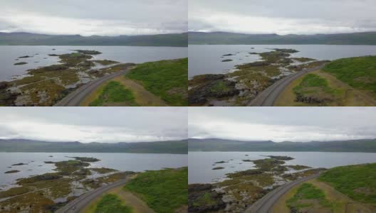 鸟瞰图美丽的道路通过一个美丽的乡村在西峡湾，冰岛高清在线视频素材下载