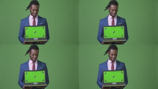 年轻英俊的非洲商人在绿色背景下梳着雷鬼辫高清在线视频素材下载