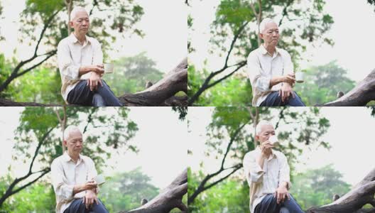 孤独的亚洲老人坐在公园里独自喝着咖啡思考着人生高清在线视频素材下载