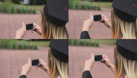 快乐学生戴着毕业帽在智能手机上拍摄朋友，过节高清在线视频素材下载
