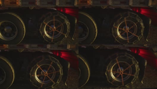 一辆半挂卡车的车轮和轮胎配备了雪链在晚上的侧面视图高清在线视频素材下载