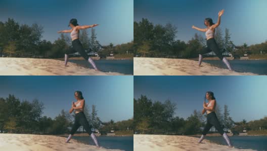 亚洲妇女在海滩上练习瑜伽健身运动。健康的生活方式高清在线视频素材下载