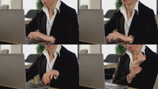 在笔记本电脑上打字的女性经理患有手腕疼痛和腕管综合症高清在线视频素材下载