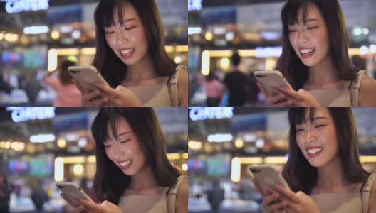 亚洲女性在晚上使用智能手机高清在线视频素材下载