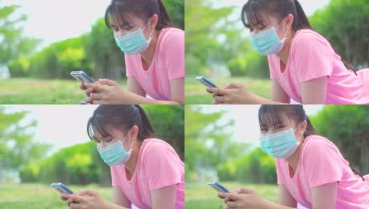 新常态，少女在新冠肺炎疫情下戴口罩使用手机高清在线视频素材下载
