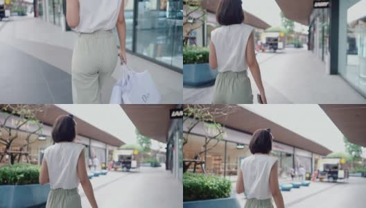 时尚人士在社区购物中心散步，拿着她的购物袋高清在线视频素材下载