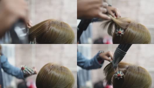 近距离亚洲发型师吹头发为她的客户在发廊高清在线视频素材下载
