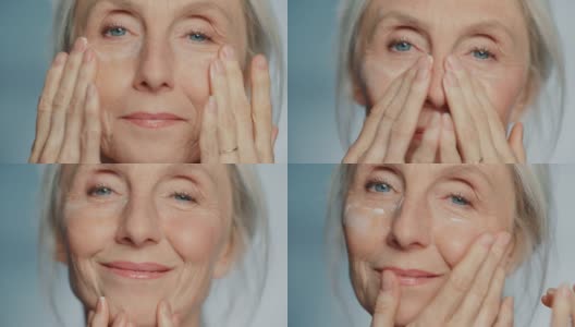 美丽资深女性肖像轻轻涂抹下眼霜。使用天然抗老化化妆品，使老妇人的皮肤柔软，光滑，无皱纹。产品为美容护肤，化妆高清在线视频素材下载