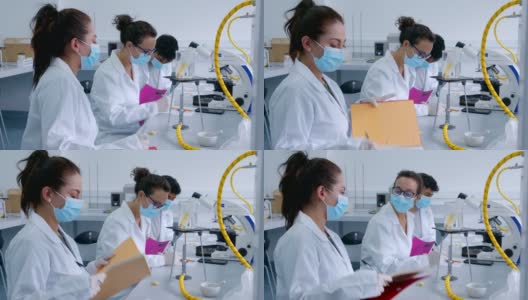 一群拉丁美洲的生物学学生在实验室里观察在试管和烧杯中加热的样品的反应高清在线视频素材下载