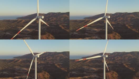 风力涡轮机叶片在风电场鸟瞰明亮的橙色日落高清在线视频素材下载