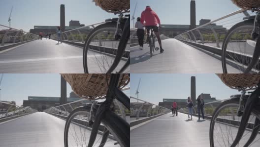 一个低角度的摄影与自行车车轮在千禧步行桥上拍摄的泰特现代美术馆，伦敦高清在线视频素材下载