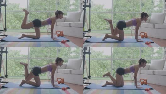 健身女性锻炼大腿肌肉，用椭圆机锻炼。美丽的亚洲女人在体育。高清在线视频素材下载