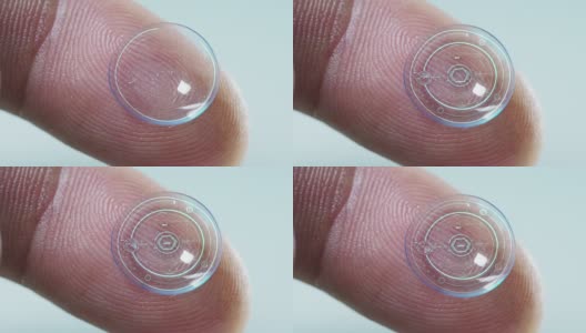 微距拍摄的手指持有的隐形眼镜技术与芯片，以看到更好的双眼和增加屈光度。概念:眼检、光学、沉浸式技术高清在线视频素材下载