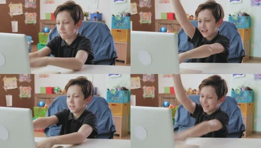 可爱的小男孩摆弄着笔记本电脑在键盘上打字高清在线视频素材下载